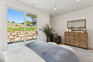 Bedroom featuring access to exterior, light carpet, and recessed lighting