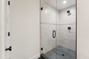 Bathroom featuring a stall shower and recessed lighting