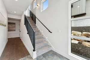 Stairway featuring recessed lighting and wood finished floors
