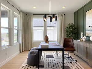 Interior space with baseboards, an inviting chandelier, light wood finished floors, and recessed lighting