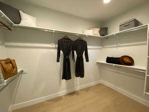 Walk in closet featuring light wood-type flooring
