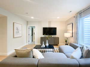 Living area with baseboards, visible vents, and recessed lighting