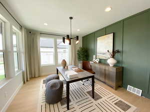 Office featuring light wood finished floors, baseboards, a notable chandelier, visible vents, and recessed lighting