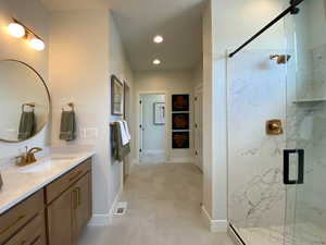 Bathroom with recessed lighting, visible vents, vanity, a marble finish shower, and baseboards
