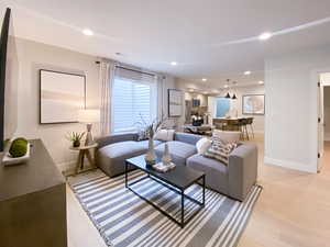 Living area with recessed lighting, visible vents, and baseboards