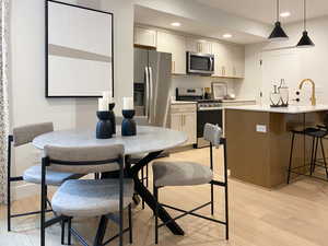 Kitchen featuring light countertops, light wood-type flooring, and appliances with stainless steel finishes