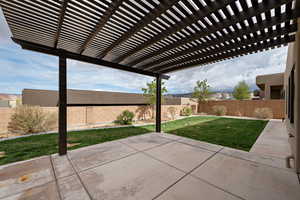 View of patio with a pergola and a fenced backyard