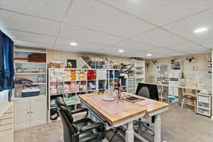 Office with light carpet, a paneled ceiling, and recessed lighting