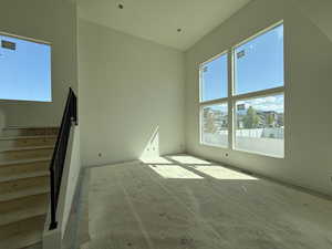 Unfurnished room featuring baseboards and stairs