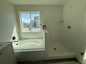 Bathroom with vanity, tile patterned flooring, walk in shower, and a bath
