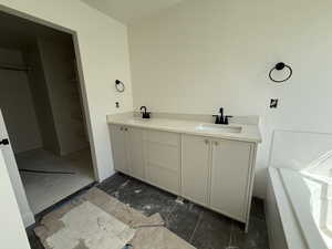 Bathroom featuring double vanity and a sink