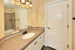 Full bath with vanity, a washtub, tile patterned flooring, and a shower