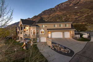 View of front of home featuring a balcony, driveway, a mountain view, a garage, and stucco siding