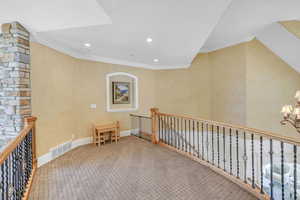 Corridor featuring recessed lighting, carpet, visible vents, ornamental molding, and an upstairs landing