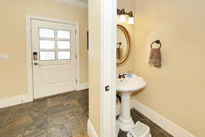Bathroom featuring stone finish flooring and baseboards