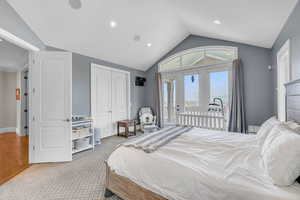 Carpeted bedroom featuring access to exterior, vaulted ceiling, baseboards, recessed lighting, and a closet