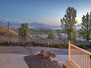Patio terrace at dusk with fence and a mountain view