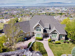 View of front of property featuring roof with shingles, a mountain view, and stone siding