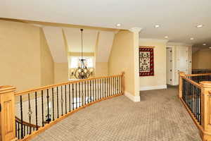 Hall with recessed lighting, an upstairs landing, baseboards, a chandelier, and carpet flooring