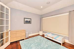 Bedroom featuring baseboards, recessed lighting, and dark wood-type flooring
