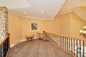 Hallway featuring visible vents, carpet, recessed lighting, an upstairs landing, and ornamental molding