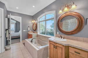 Bathroom featuring recessed lighting, tile patterned floors, a jetted tub, connected bathroom, and a sink