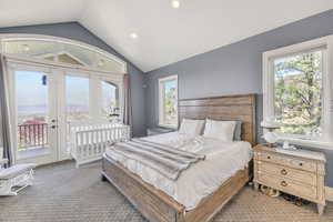 Bedroom with recessed lighting, lofted ceiling, carpet floors, and access to exterior