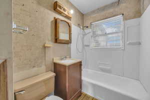 Full bathroom with toilet, vanity, and shower / bath combination