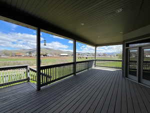 Wooden deck featuring a mountain view with buffalo