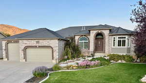 French country style house featuring a garage, brick siding