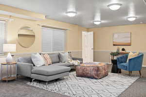 Living area featuring carpet and baseboards