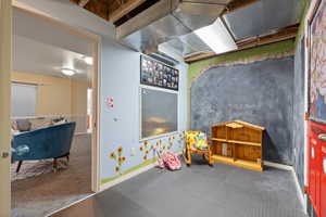 Game room with baseboards and carpet flooring