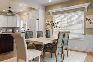 Dining area featuring wainscoting, a ceiling fan, and recessed lighting