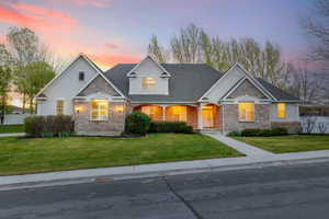 View of front of house featuring a lawn and stucco siding