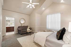 Bedroom featuring high vaulted ceiling, a ceiling fan, light carpet, baseboards, and ensuite bath