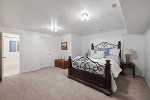 Carpeted bedroom with baseboards and a textured ceiling