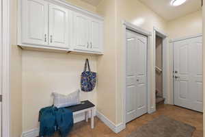 Mudroom with baseboards and tile patterned flooring