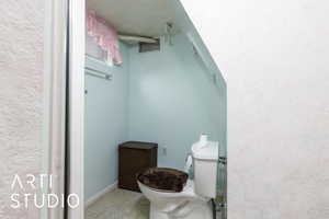 Bathroom with visible vents, baseboards, and toilet
