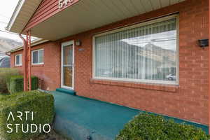 Property entrance featuring brick siding