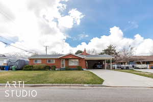 Ranch-style home with a carport, a front lawn, brick siding, a chimney, and driveway