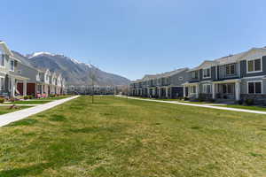 Surrounding community featuring a yard, a mountain view, and a residential view