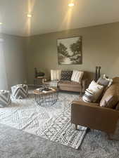Carpeted living area featuring recessed lighting