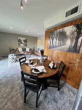 Carpeted dining space featuring recessed lighting and visible vents