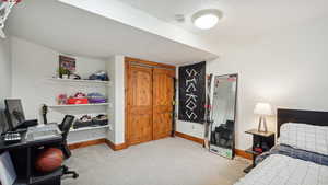 Bedroom with light carpet and baseboards