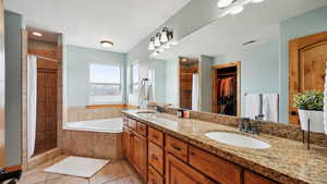 Full bathroom with tile patterned floors, a sink, and a tile shower