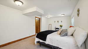 Bedroom featuring carpet floors and baseboards