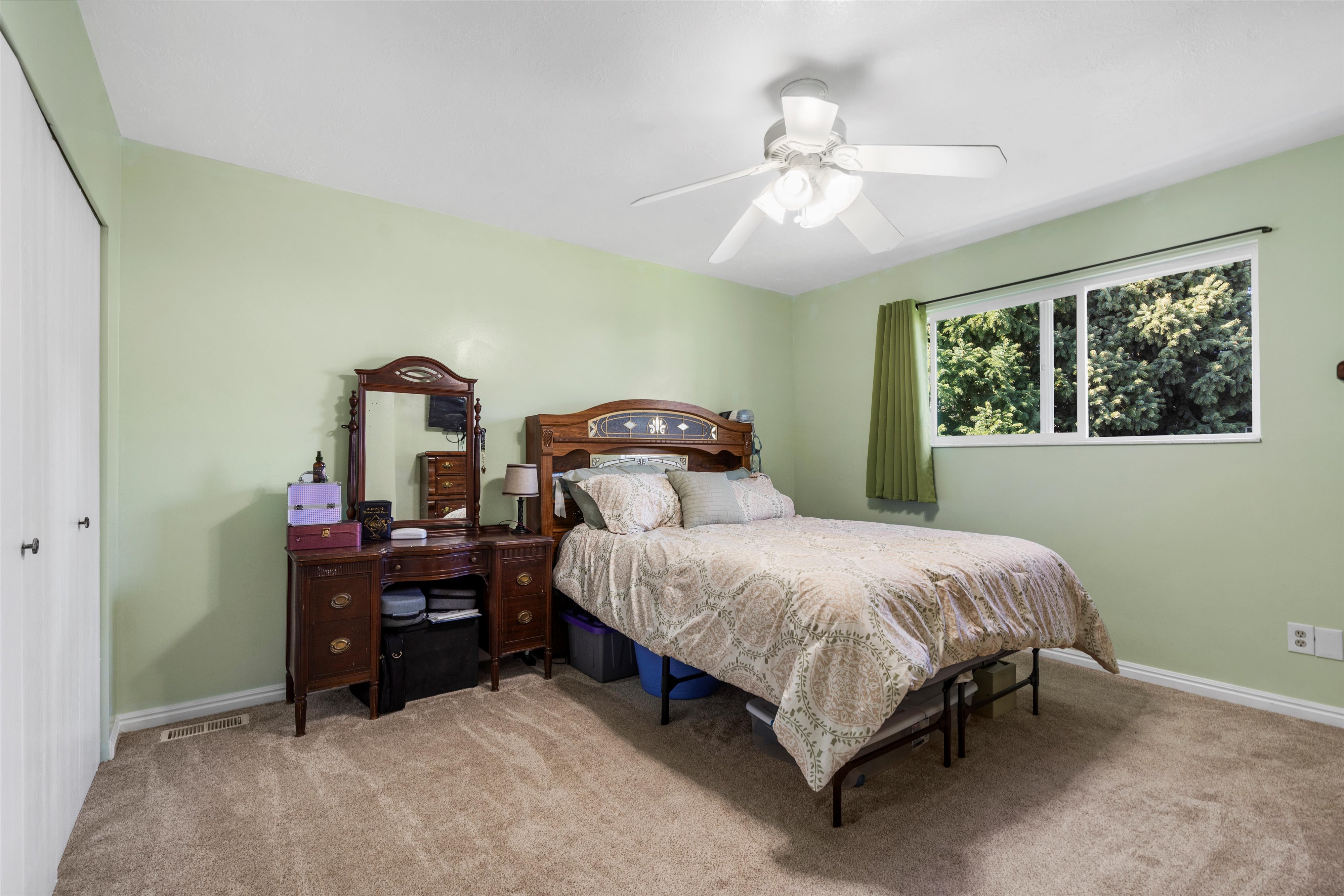 Carpeted bedroom featuring a closet, baseboards, a ceiling fan, and visible vents