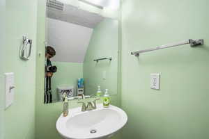 Bathroom featuring a sink, visible vents, and a textured ceiling