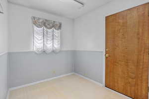 Empty room featuring baseboards and tile patterned floors
