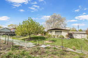 Exterior space featuring fence, a gate, and a front yard